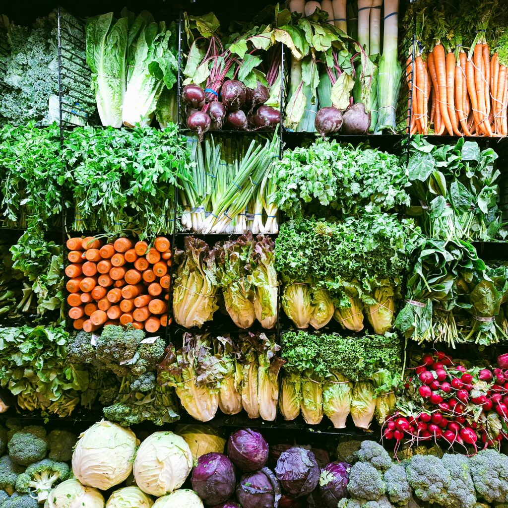 Diverse selection of fresh vegetables artfully arranged in a vibrant market display.